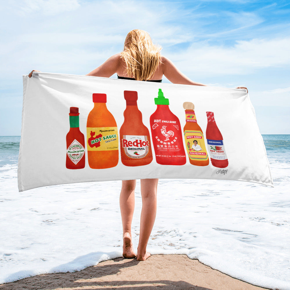 Hand-illustrated hot sauce bottle beach towel in bold red and green colors, printed on one side, 30x60 inches. Perfect for hot sauce lovers, beach days, poolside lounging, and summer statement gifts. Designed by Lindsey Kay Collective.
